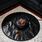 Glossy black protective mat with electric coil coal burner and glowing coals